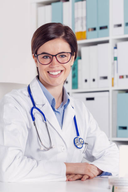 istock Smiling friendly female doctor in an office 1059835858