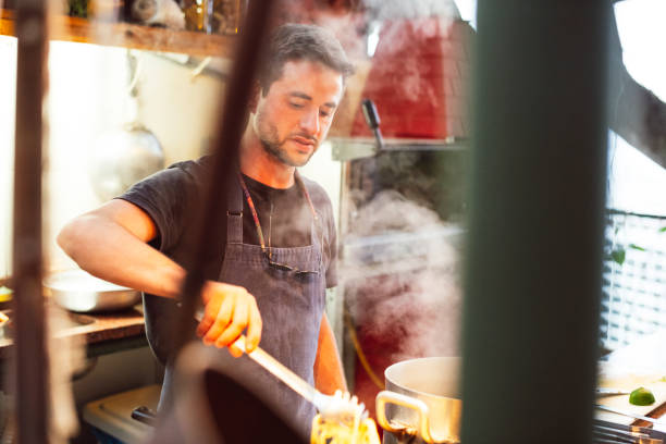 istock Busy chef cooking pasta in kitchen 1059836254