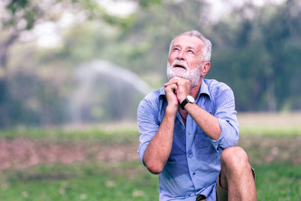 Senior old man Sit down on the grass, plead with God,Health elderly concept
