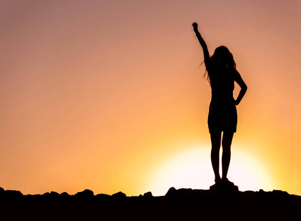 istock Success with arm outstretched celebrate mountains sunrise 1059839364