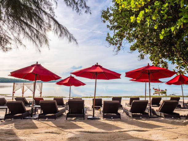istock Lounge Chairs With Parasols At Beach Against Sky 1059841708
