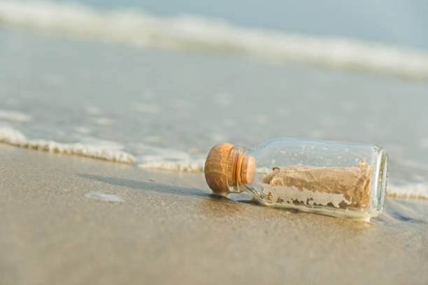 istock Close-Up Of Bottle On Sand At Beach 1059845978