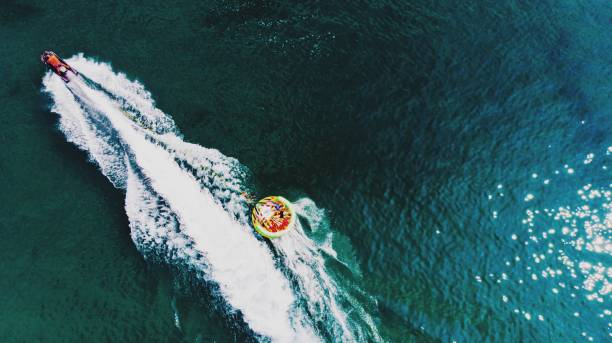 high angle view of people playing aquatic sport - wake jet boat water water sport imagens e fotografias de stock