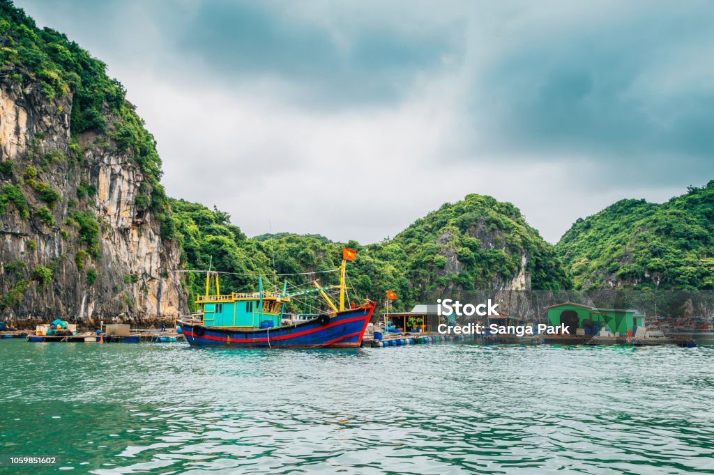Floating fishing village and rock island at Lan Ha Bay, Ha long Bay tour in Vietnam Adventure Stock Photo