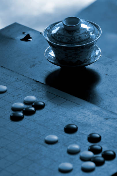 istock Traditional Chinese Tea Pot Set and stones on a Go board 1059867310