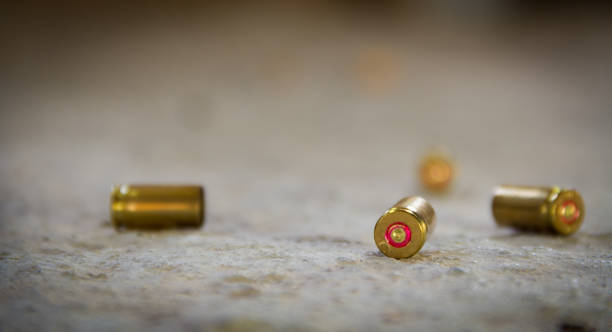 9 mm bullet shells lying on the ground bullet cartridge photos stock pictures, royalty-free photos & images