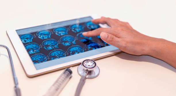 istock Midsection Of Doctor Analyzing X-Ray In Digital Tablet At Table In Hospital 1059870596