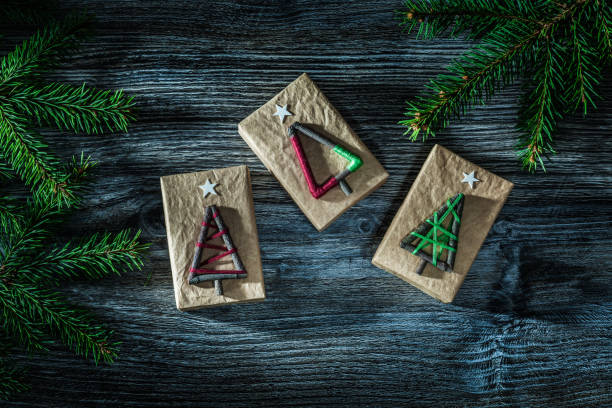 istock Present boxes fir branch on wooden board 1059876570
