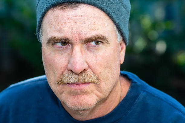 istock Older man glares outdoors 1059893296