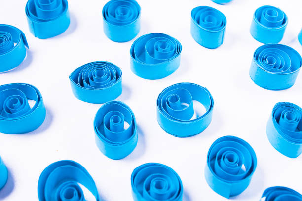 Quilling art. Blue paper curls on the white background