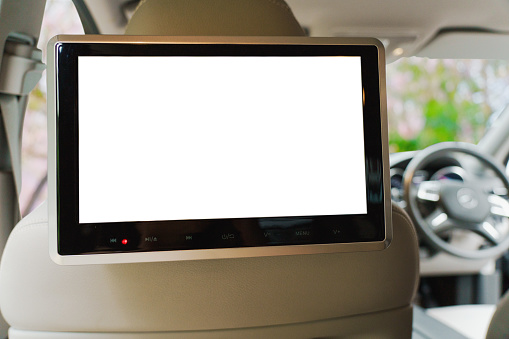 Small monitor TV led white screen display inside luxury car for entertain.