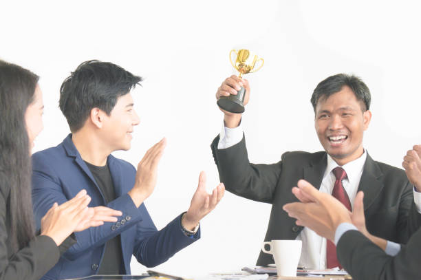 istock Businessman get award trophy for achievement with successful team 1059898584