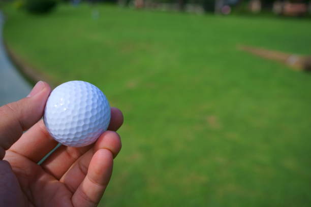 istock Golf ball and tee on golf green course background, copy space 1059900542