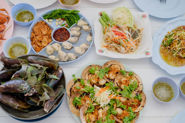 istock special Thai seafood (fish fried, Fried rice with crab, Crab's spawn salad, papaya salad, shrimp,Herb Roasted Mussels) on white table background. party concept. 1059902036