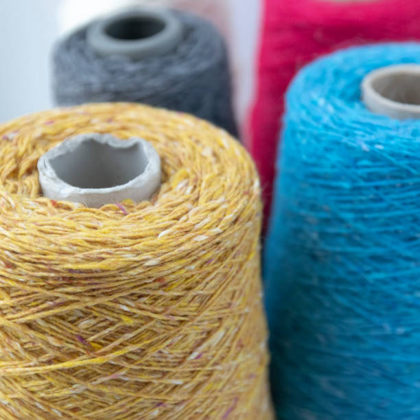 istock Multi-colored bobbins of wool yarn for hand and machine knitting 1059903842