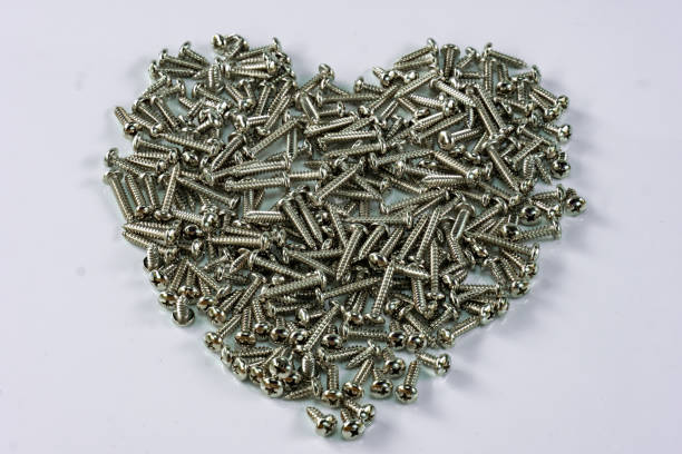 istock Heart shaped stainless steel screw background 1059907430