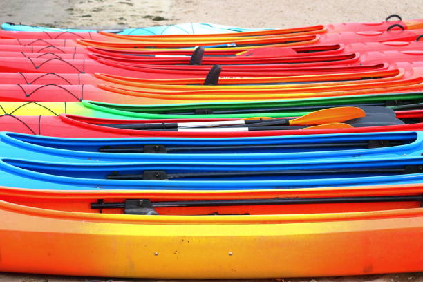 istock Many bright colored kayaks on sand shore at autumn cloudy day 1059909320