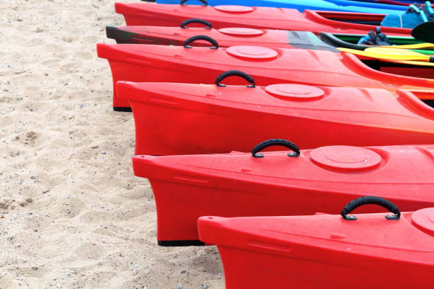 istock Many bright colored kayaks on sand shore at autumn cloudy day 1059909442
