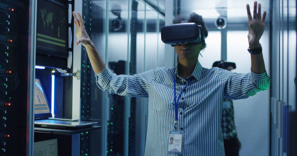 istock Ethnic woman in VR glasses working in data center 1059910980