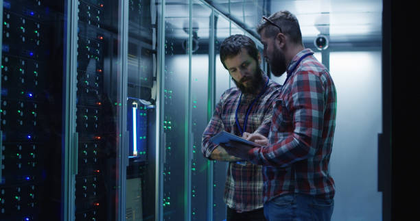 istock Coworking adult men diagnosing server hardware 1059910994