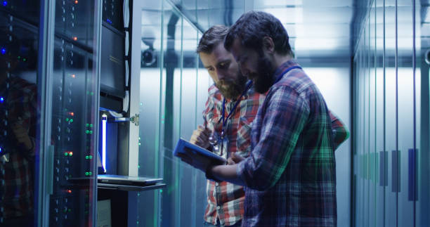 istock Coworking adult men diagnosing server hardware 1059911004