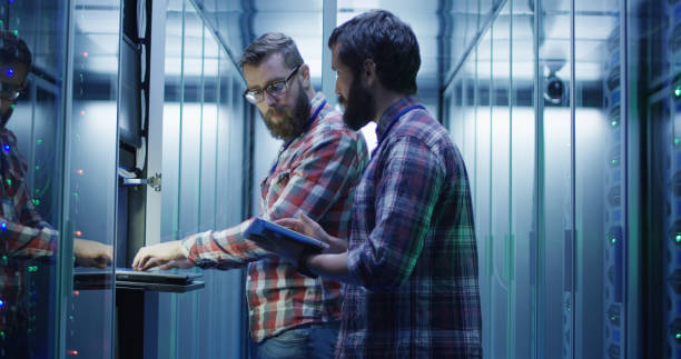 istock Coworking adult men diagnosing server hardware 1059911008