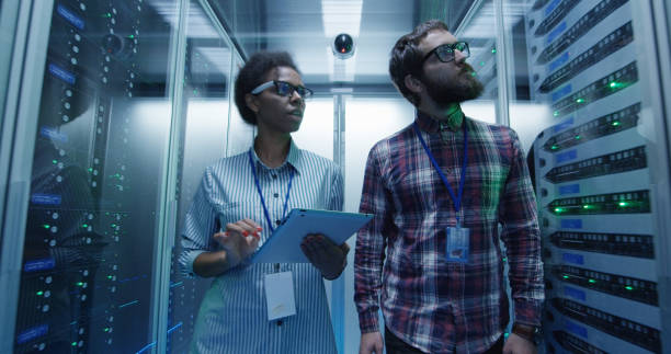 istock Diverse coworkers walking in server room 1059911032