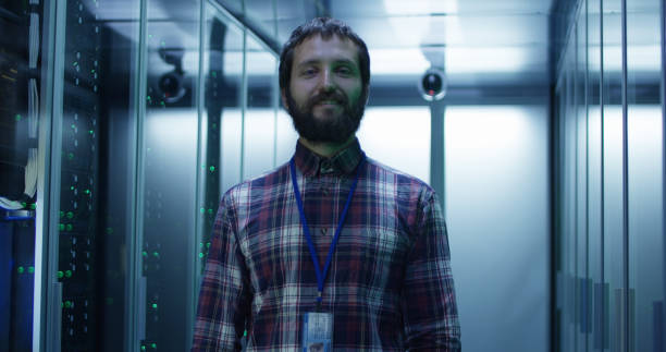 istock Adult bearded engineer in server room 1059911094