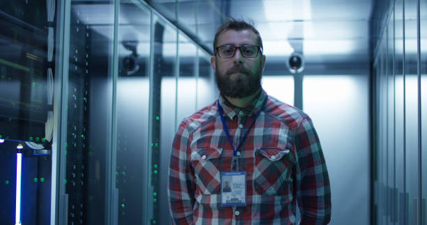 istock Adult bearded engineer in server room 1059911096