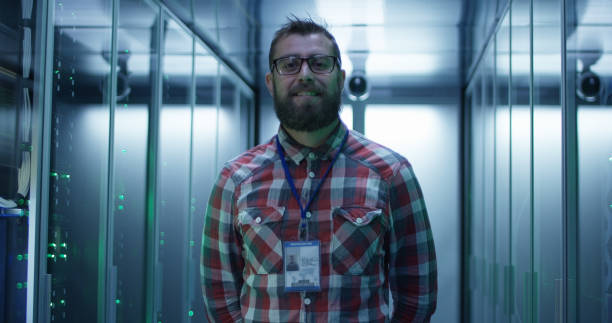 istock Adult bearded engineer in server room 1059911098