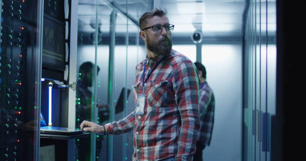 istock Coworking men in modern server room of data center 1059911130