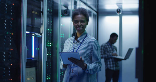 istock Smiling ethnic woman in data center 1059911138