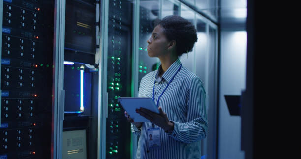 istock Smiling ethnic woman in data center 1059911154