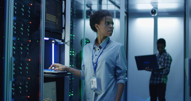 istock Smiling ethnic woman in data center 1059912500