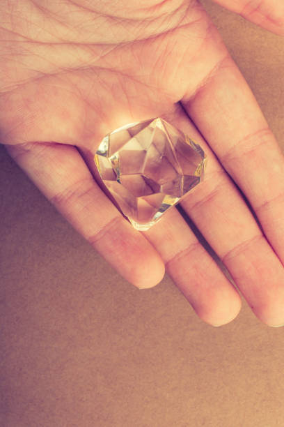 istock Fake diamond stone in hand 1059918918