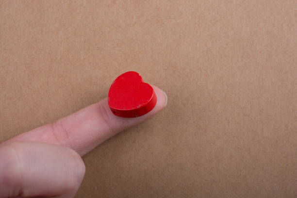 istock Red color heart shaped object ion finger 1059918932