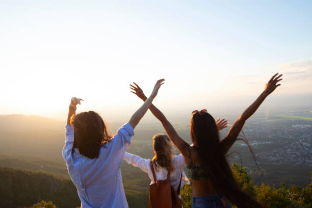 istock Women on mountain peak cliff 1059920900