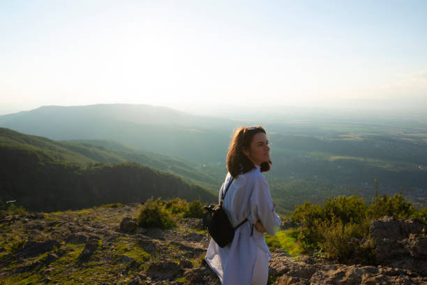 istock Young woman on mountain peak cliff 1059920902