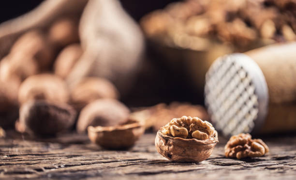 istock Walnut kernels whole walnuts in burlap sack and vintage bowl. 1059922614