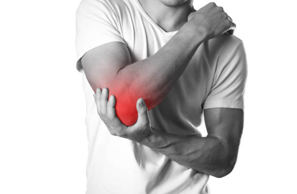 a man holding hands. pain in the elbow. the hearth is highlighted in red. close up. isolated on white background - elbow imagens e fotografias de stock