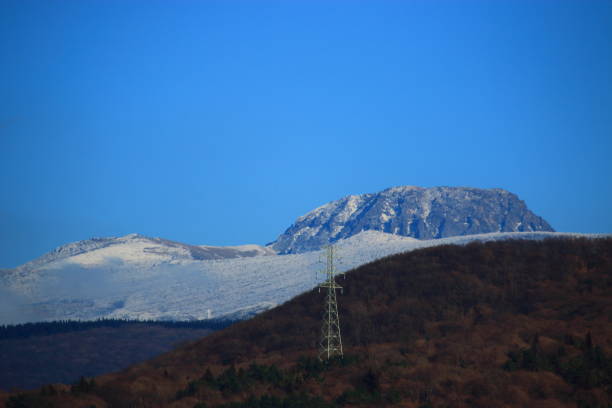 Mountains with snow and clouds over