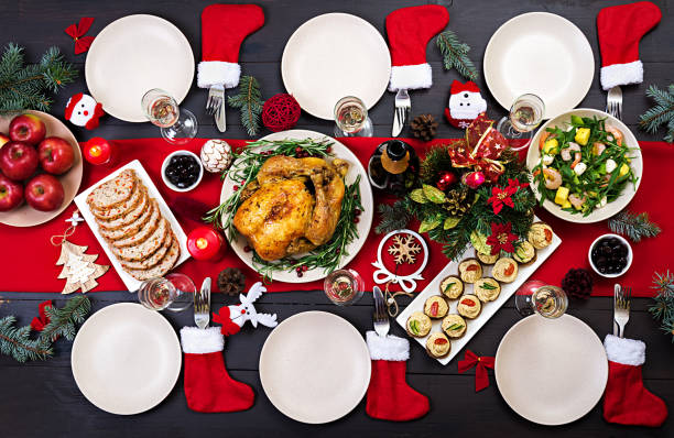 istock Baked turkey. Christmas dinner. The Christmas table is served with a turkey, decorated with bright tinsel and candles. Fried chicken, table.  Family dinner. Top view 1059931220