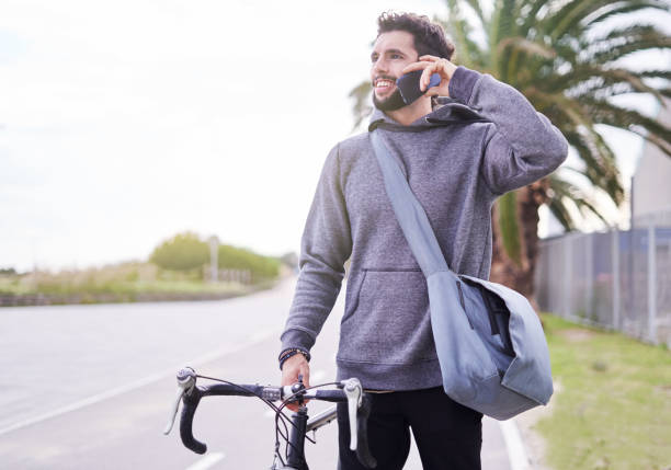 istock Young commuter with a bicycle and smart phone. 1059941436