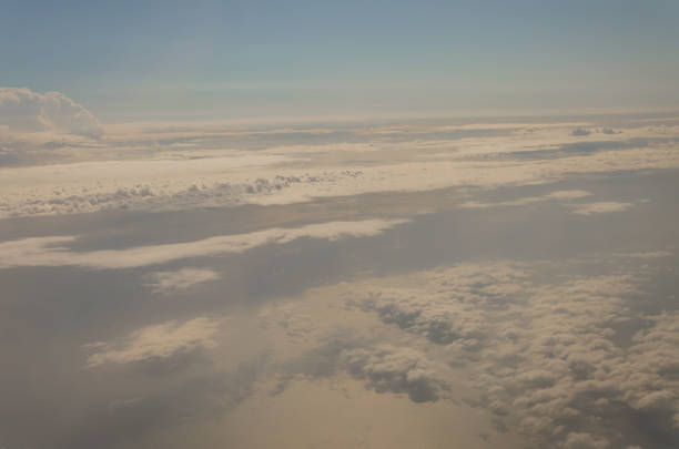 istock Picture of airplane wing, cloudy sky from porthole 1059943680