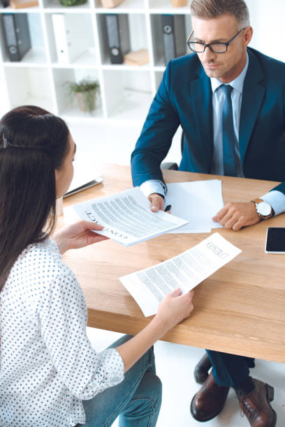 istock high angle view of lawyer and client discussing contract 1059944168