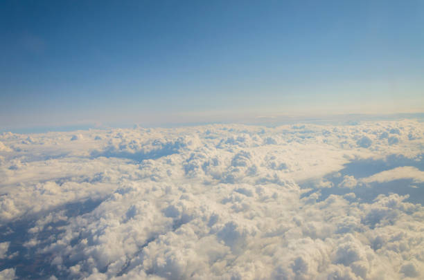 istock Picture of airplane wing, cloudy sky from porthole 1059944462