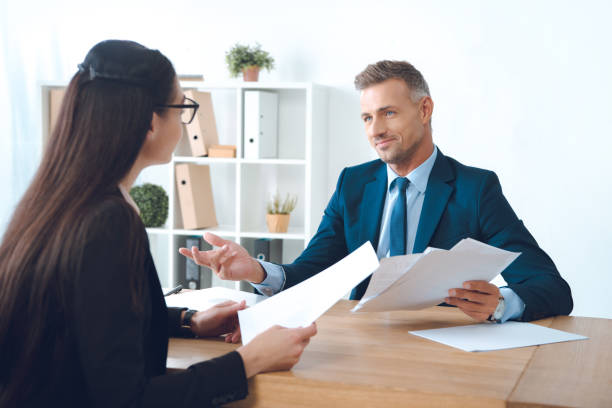 istock business partners with papers discussing work at workplace in office 1059944646