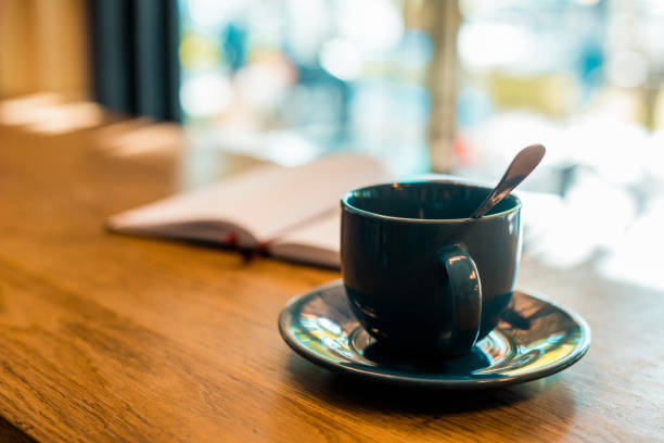 istock cup of coffee with spoon on wooden tabletop in cafe 1059944942