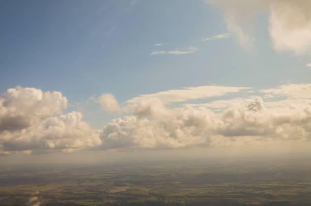 istock Picture of airplane wing, cloudy sky from porthole 1059948582