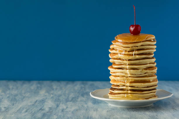 Pancakes with maple syrup and butter on a bar table